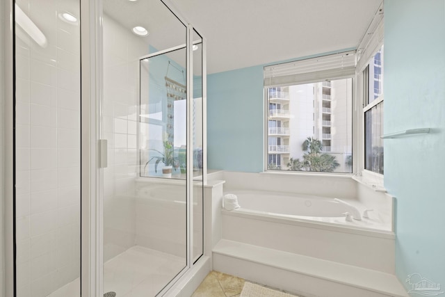 bathroom featuring a wealth of natural light, tile patterned flooring, and shower with separate bathtub