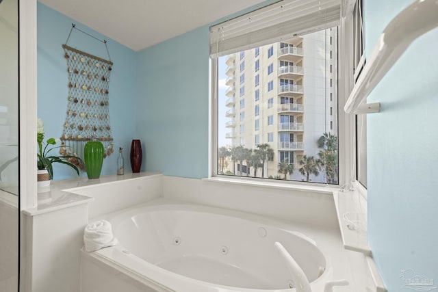 bathroom featuring tiled tub