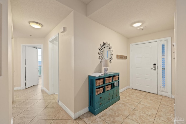 tiled entrance foyer with a textured ceiling