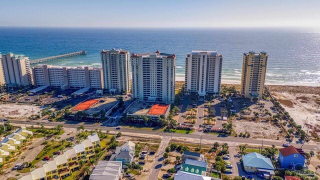 birds eye view of property with a water view and a view of the beach