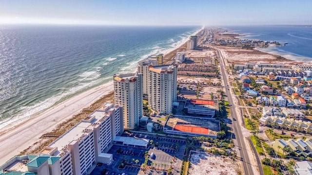 drone / aerial view with a water view and a beach view