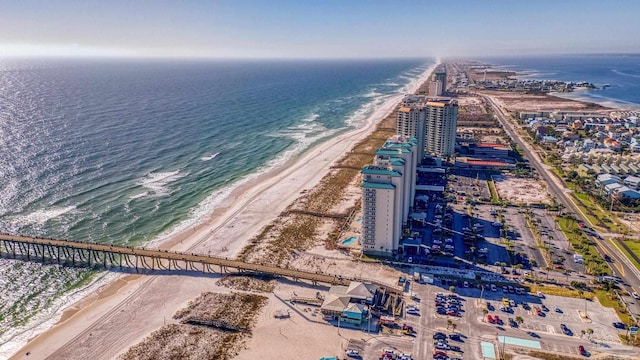 birds eye view of property with a water view and a view of the beach