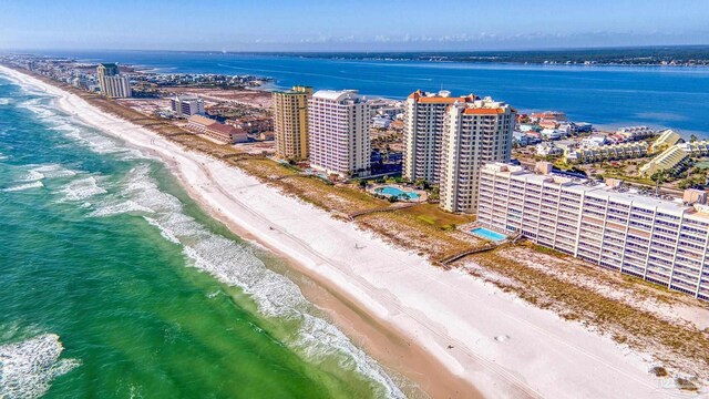 drone / aerial view with a water view and a beach view