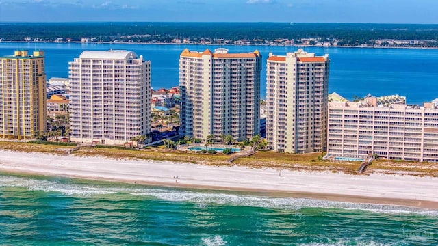 bird's eye view featuring a water view and a beach view