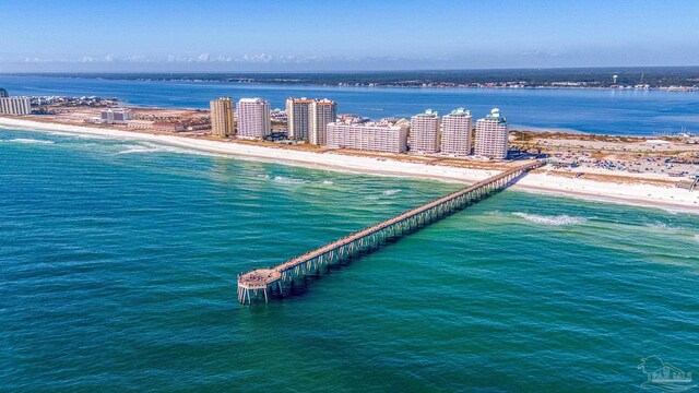 birds eye view of property featuring a water view and a beach view