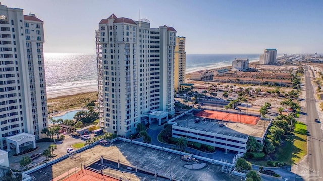 bird's eye view featuring a water view and a beach view