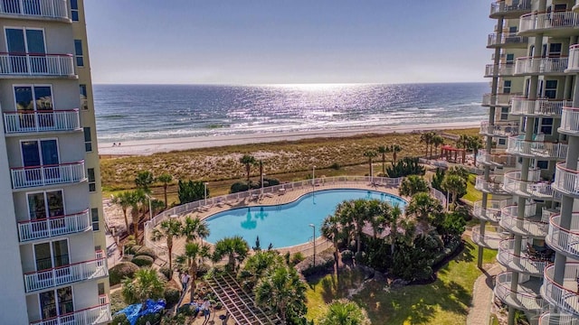 view of pool featuring a water view and a view of the beach