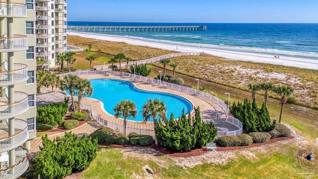 view of swimming pool with a view of the beach and a water view