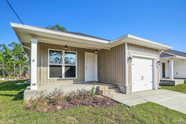 view of front of house with a garage, concrete driveway, a porch, and board and batten siding