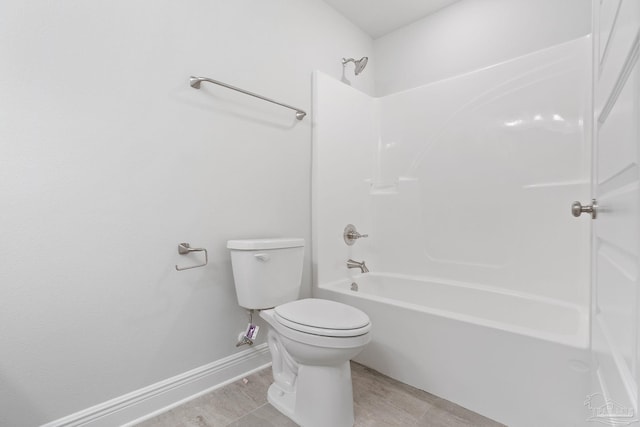 bathroom with shower / bathtub combination, toilet, and tile patterned flooring