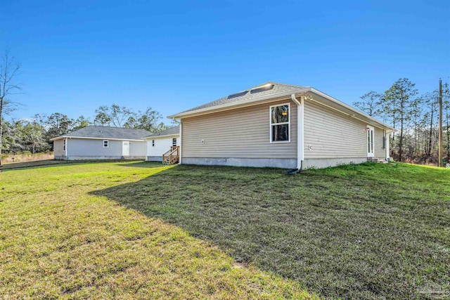 back of property featuring a lawn