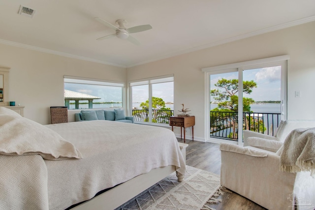 bedroom featuring a water view, ornamental molding, light wood-type flooring, and access to outside