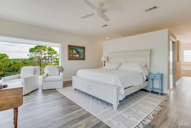 bedroom featuring hardwood / wood-style flooring, ornamental molding, and ceiling fan