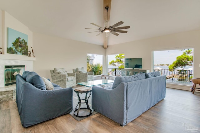 living room featuring hardwood / wood-style flooring, vaulted ceiling, and ceiling fan