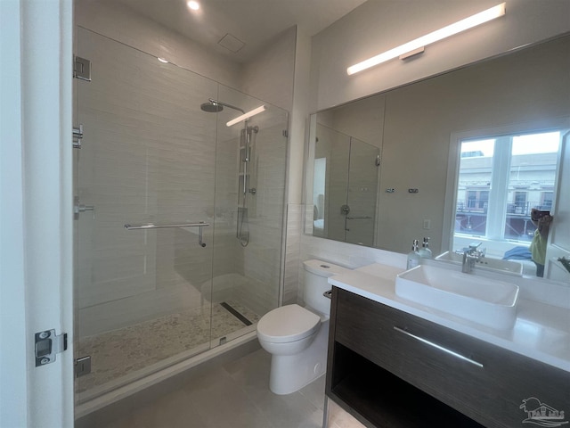 full bathroom featuring vanity, tile patterned flooring, a shower stall, and toilet