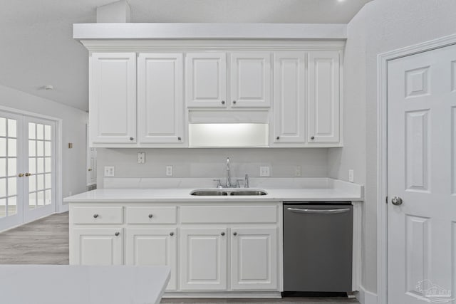 kitchen with french doors, light wood-type flooring, stainless steel dishwasher, sink, and white cabinets