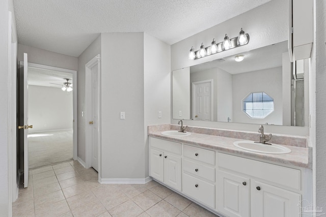 bathroom featuring vanity, a textured ceiling, tile patterned floors, and ceiling fan