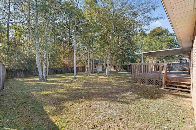 view of yard featuring a wooden deck and a shed