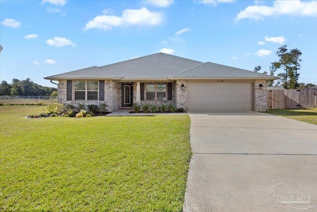 ranch-style home with a garage and a front yard