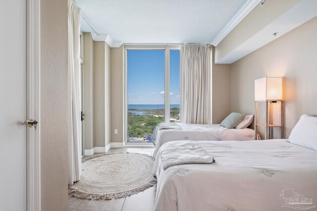 4 Portofino Dr Unit 803, Pensacola Beach, FL 32561 - bedroom with floor to ceiling windows, tile patterned floors, and a water view