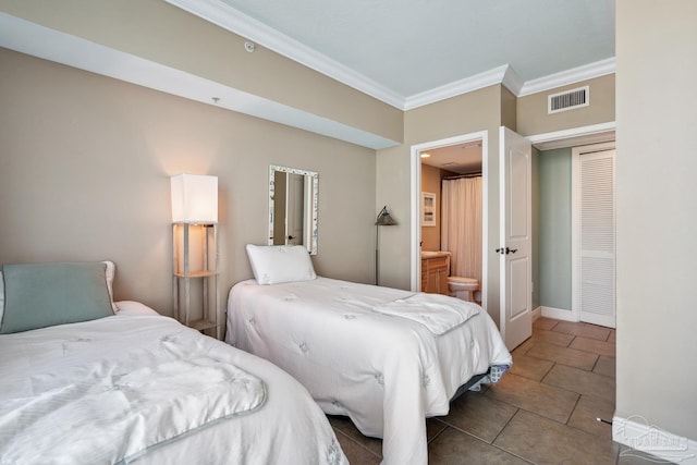4 Portofino Dr Unit 803, Pensacola Beach, FL 32561 - tiled bedroom featuring ornamental molding, ensuite bath, and baseboards