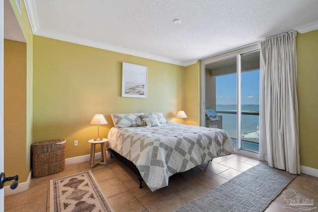 4 Portofino Dr Unit 803, Pensacola Beach, FL 32561 - tiled bedroom with access to outside, ornamental molding, a water view, a textured ceiling, and baseboards
