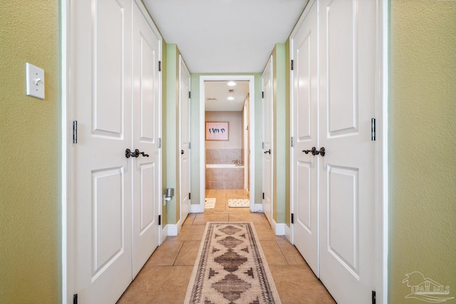 4 Portofino Dr Unit 803, Pensacola Beach, FL 32561 - hallway featuring light tile patterned flooring and baseboards