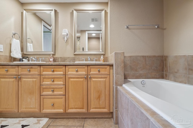 4 Portofino Dr Unit 803, Pensacola Beach, FL 32561 - bathroom with a garden tub, double vanity, and tile patterned flooring