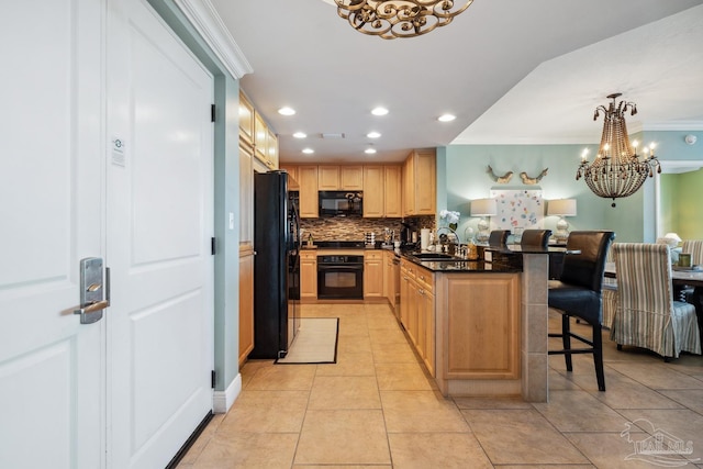 4 Portofino Dr Unit 803, Pensacola Beach, FL 32561 - kitchen featuring black appliances, a chandelier, a sink, a kitchen bar, and recessed lighting
