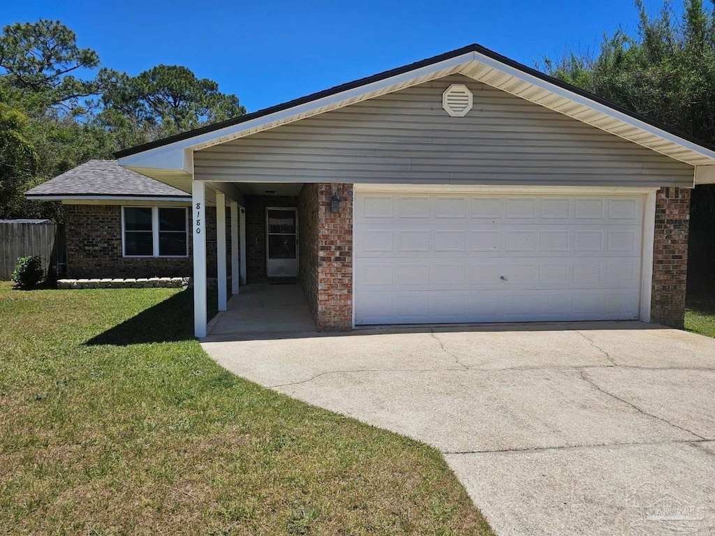 8180 Sedgefield Dr, Pensacola, FL 32507 - ranch-style house with brick siding, driveway, a front lawn, and a garage