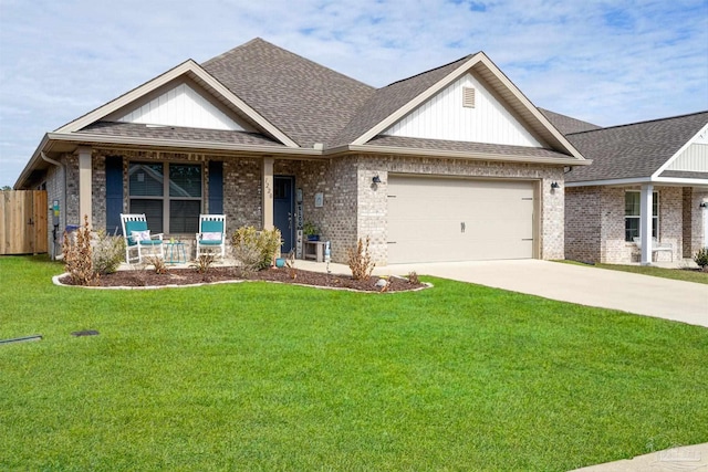 view of front of home featuring a garage, a front lawn, and covered porch