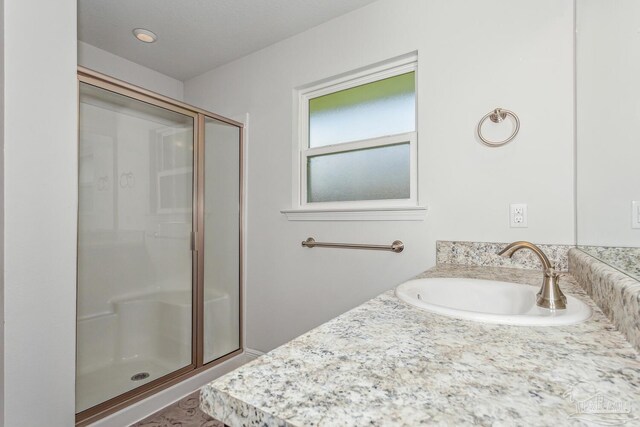 bathroom with vanity and an enclosed shower