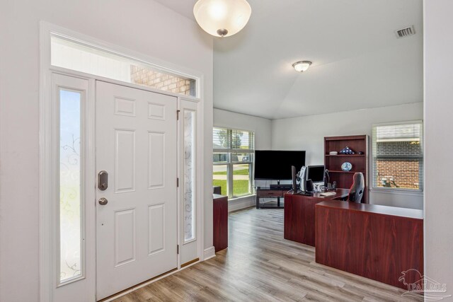 entryway featuring light hardwood / wood-style flooring and lofted ceiling