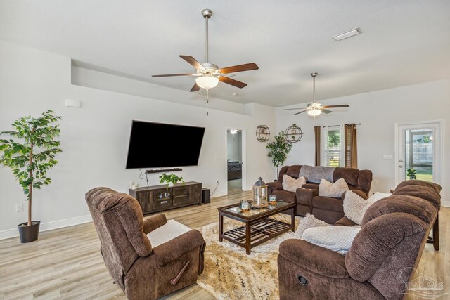 living room with light wood-type flooring and ceiling fan