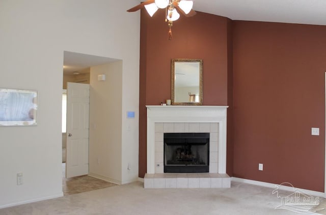 unfurnished living room with carpet, baseboards, a tiled fireplace, high vaulted ceiling, and ceiling fan