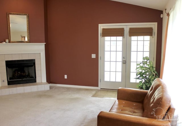 living area featuring a fireplace, lofted ceiling, and a wealth of natural light