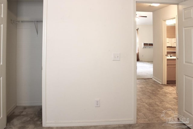 interior space with baseboards, a sink, and a closet