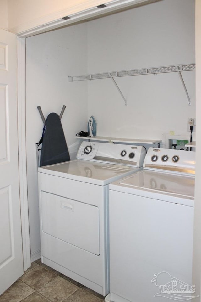 washroom featuring washing machine and clothes dryer and laundry area