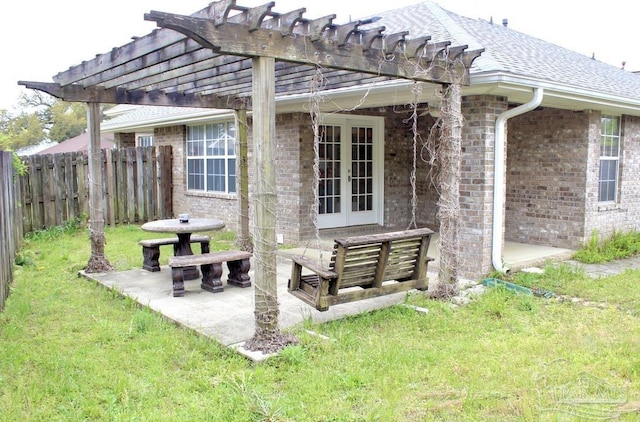 view of patio with fence, a pergola, and french doors