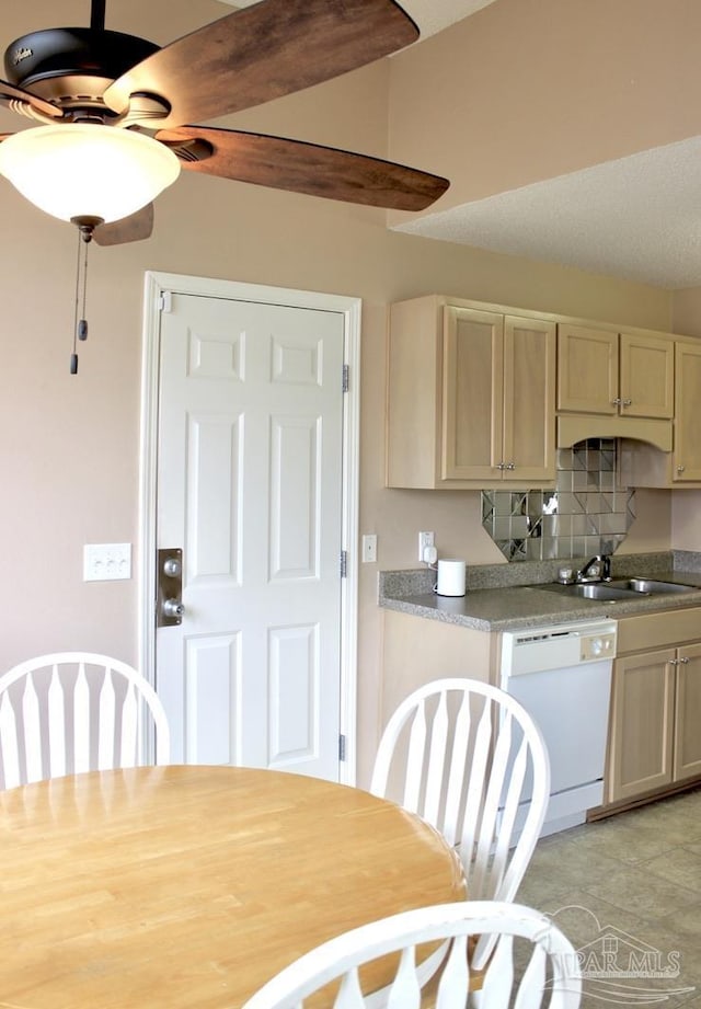 kitchen featuring dishwasher, light countertops, and a sink