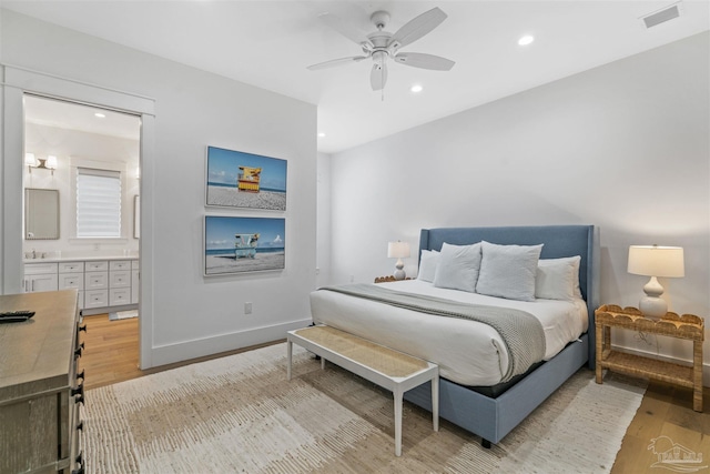 bedroom featuring connected bathroom, ceiling fan, and light hardwood / wood-style floors