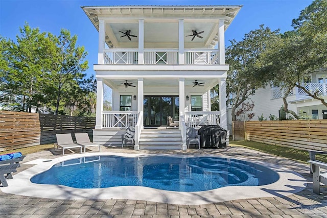 back of property featuring a pool side deck and a balcony