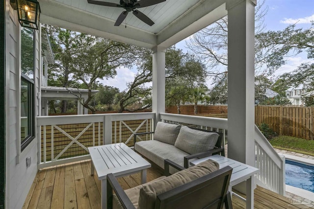 wooden terrace featuring a fenced in pool, ceiling fan, and an outdoor hangout area