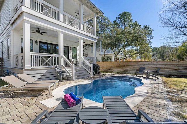 view of swimming pool featuring ceiling fan and a patio