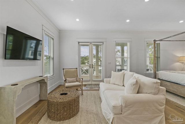 interior space with french doors, ornamental molding, and hardwood / wood-style flooring