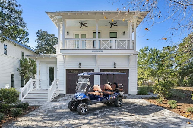 view of front of property featuring ceiling fan and a garage