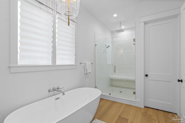 bathroom with wood-type flooring and separate shower and tub