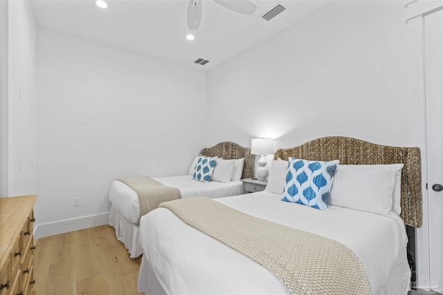 bedroom with ceiling fan and light hardwood / wood-style floors