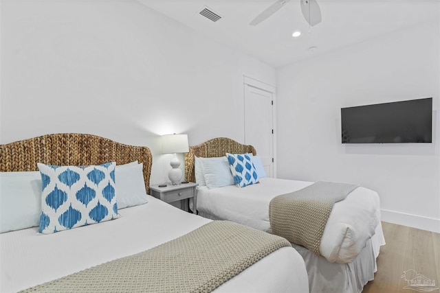 bedroom with wood-type flooring and ceiling fan