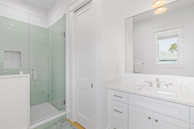 bathroom with vanity and a shower with shower door